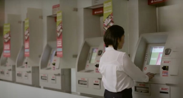 Cajeros automáticos Banco Santander Mujer utilizando un cajero automático del Banco Santander